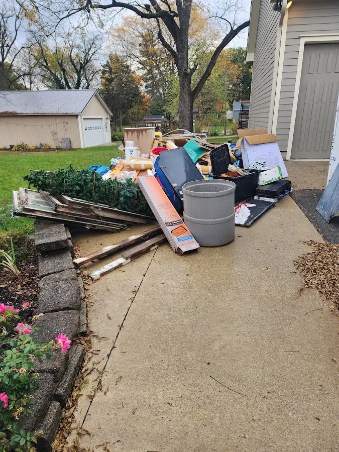 Dumpster being loaded with debris for 3 Yard Dumpster Rental in Harahan